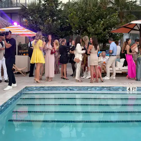 Guests gathered poolside at an evening reception