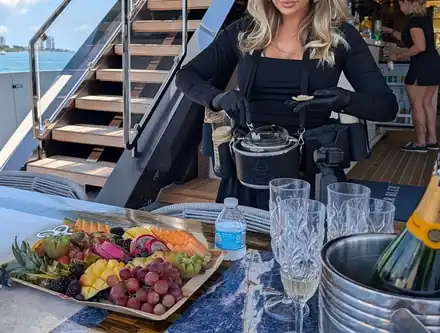 An attendant plating caviar on a yacht deck